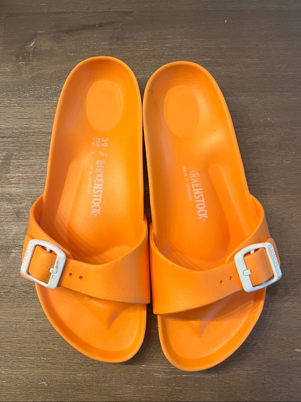 Birkenstock women’s Orange Single-Buckle EVA Slide Sandals with White Buckles